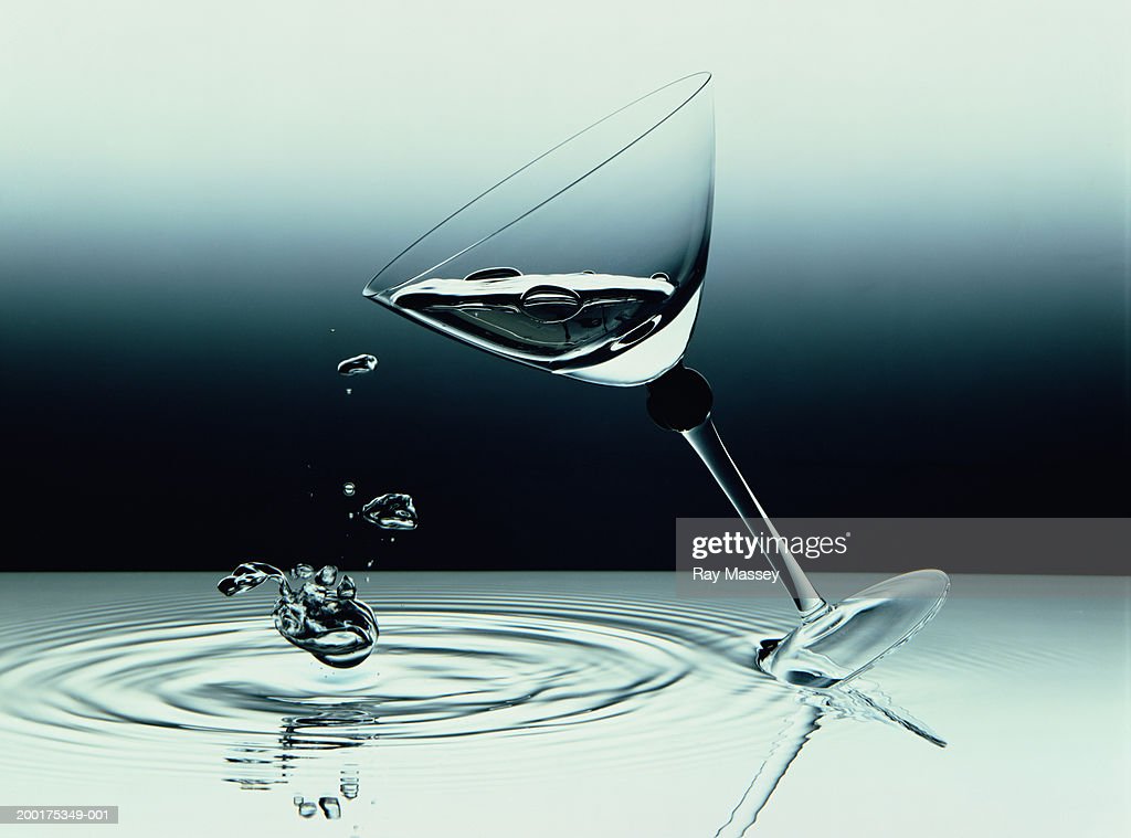 cocktail-glass-tipping-over-in-water-picture-id200175349-001